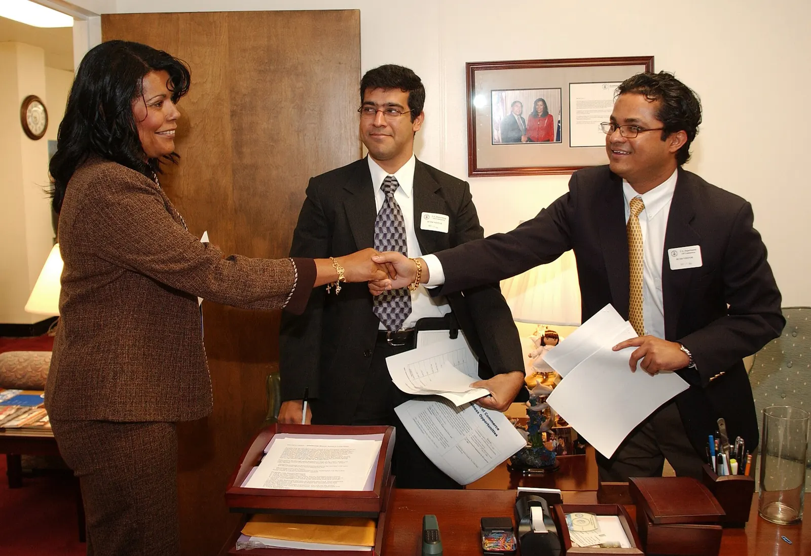 Business partners shaking hands in an office — From Cost Center to Profit Driver