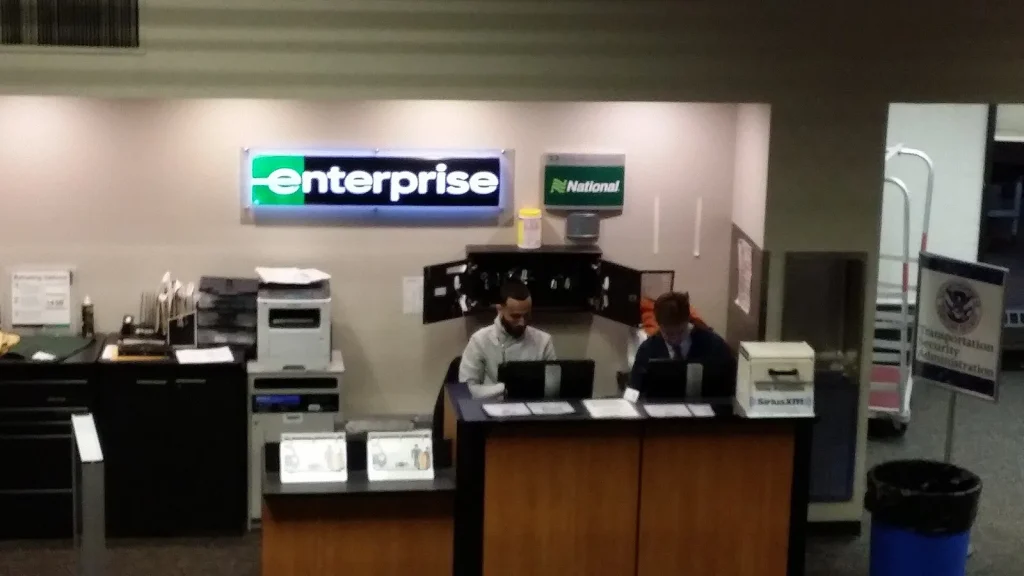 Car rental branch office with staff at the booking desk — Best Car Rental Software in the UAE