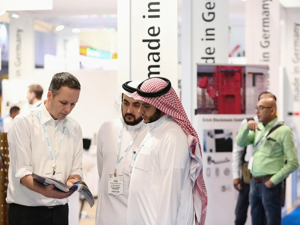 Business visitors meeting at a Dubai trade exhibition — b2b marketing strategy uae