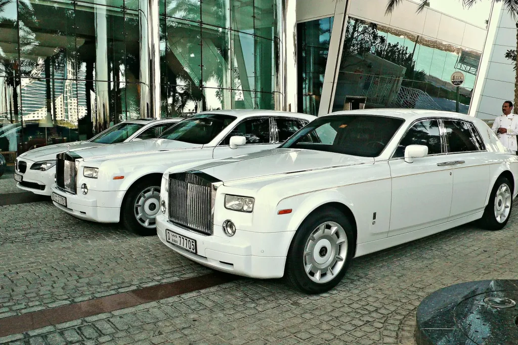 White Rolls-Royce cars parked outside a Dubai hotel — How to Market a Luxury Car Rental in Dubai