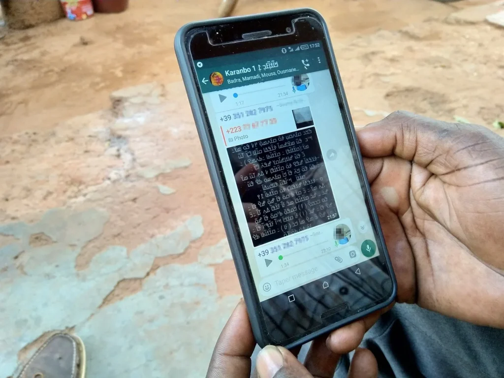 Hand holding a smartphone with a WhatsApp chat open — WhatsApp Lead Handling for Car Dealers